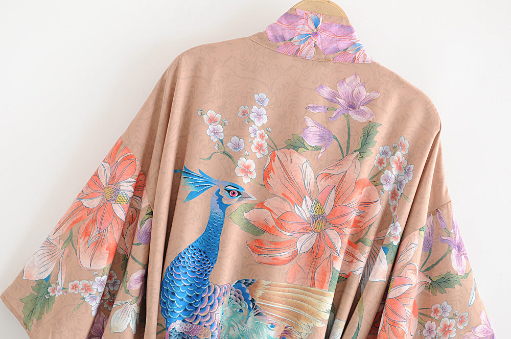 Peacock and botanical floral print detail on brown kimono robe