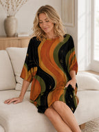 May include: A loose-fitting short-sleeved dress featuring a black background with wavy vertical stripes in shades of orange, yellow, and olive green. The fabric pattern includes small celestial motifs like stars and crescent moons throughout the design.