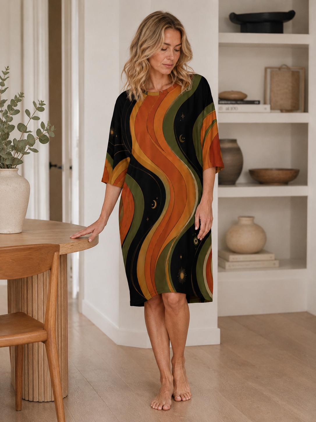 May include: A knee-length dress with short sleeves featuring a wavy, vertical pattern in shades of black, olive green, and burnt orange. The fabric design includes small celestial motifs like stars and crescent moons scattered throughout the print.