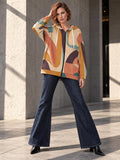 Retro abstract earth-tone longline zip hoodie on model, front editorial view